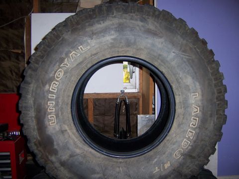 1991 Ford Bronco - A close-up view of a Uniroyal Laredo M/T tire, showing its tread and sidewall markings.