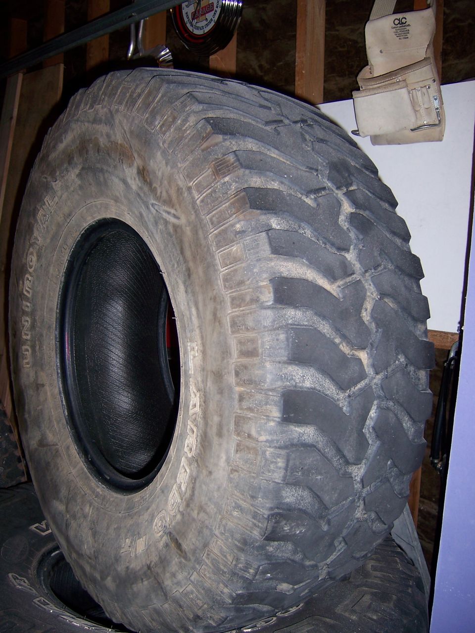 Tire with aggressive tread pattern, Continental brand visible on sidewall