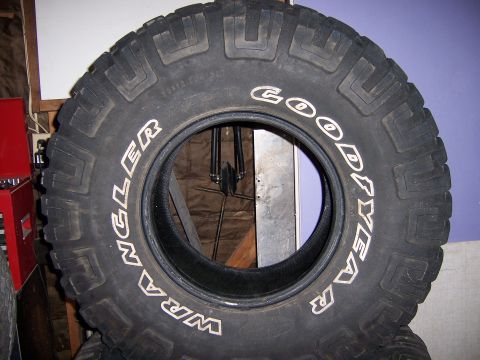1991 Ford Bronco - A close-up view of a Goodyear Wrangler tire, showing its tread pattern and white lettering.