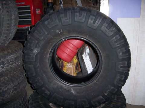 1991 Ford Bronco - A close-up view of a large tire, with a red gas can visible through the center.