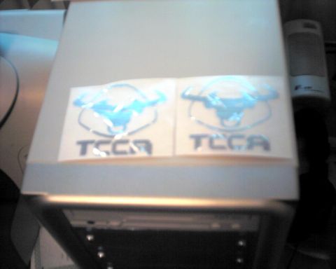 1990 Ford Taurus - Two TCCA decals are visible on a light-colored surface, possibly a car part or accessory.
