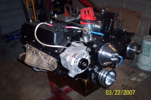 1979 Ford Bronco - Close-up of a rebuilt engine assembly, showing various components like the alternator and distributor.