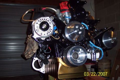 1979 Ford Bronco - Engine assembly with polished pulleys and a red distributor cap is shown.