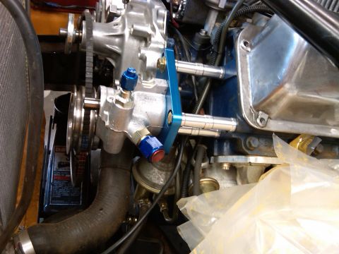 1978 Ford Mustang II - Close-up of a chrome power steering pump with blue fittings, part of an engine bay.