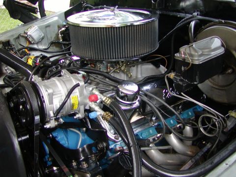 1979 Ford Bronco - Close-up view of a V8 engine, a chrome air cleaner and an AC compressor.