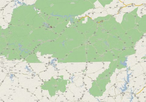 1985 Ford LTD Crown Victoria - A map displays roads and lakes within a large green area, likely a national park or forest.