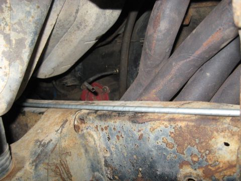 1978 Ford Bronco - Engine exhaust manifold and fuel filter assembly visible on a vehicle's undercarriage.