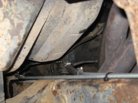 1978 Ford Bronco - Close-up view of the undercarriage of a vehicle, highlighting fuel lines and exhaust system components.