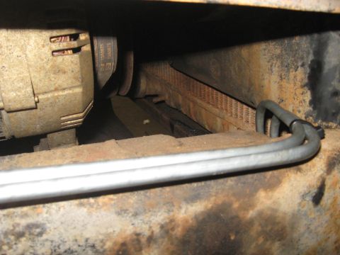 1978 Ford Bronco - Alternator and belt assembly with visible part numbers, likely from an older vehicle.