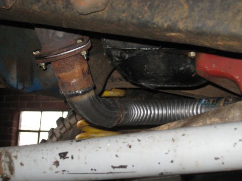 1978 Ford Bronco - Undercarriage view showing a custom exhaust pipe installation with visible suspension components.