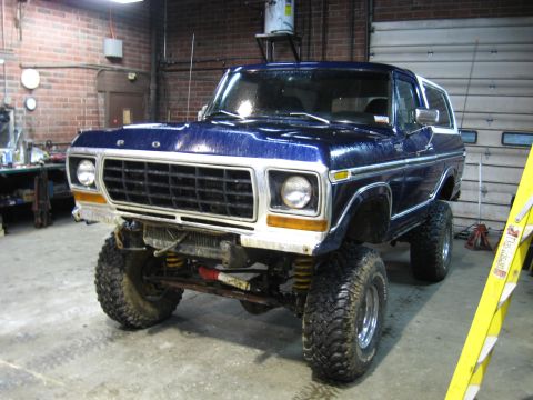 1978 Ford Bronco - This lifted 1978 Ford Bronco features a dark blue paint job and aggressive off-road tires, suggesting it's ready for adventure.