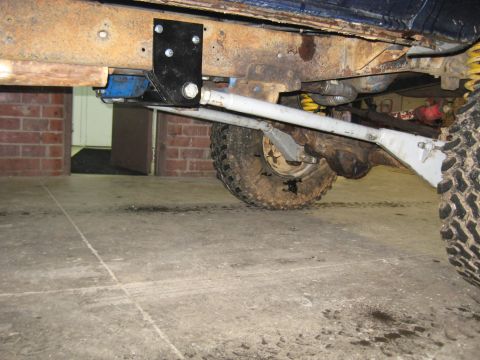 1978 Ford Bronco - Close-up view of a vehicle's undercarriage, highlighting suspension and frame components.