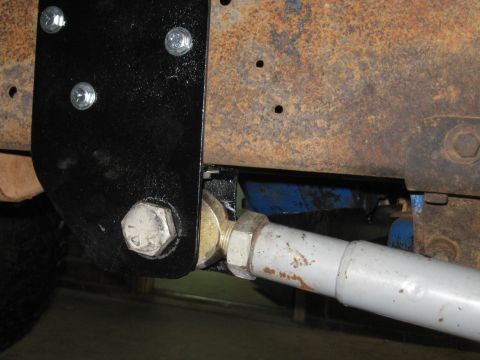 1978 Ford Bronco - A close-up view of a vehicle's suspension system, showing a linkage attached to the frame.