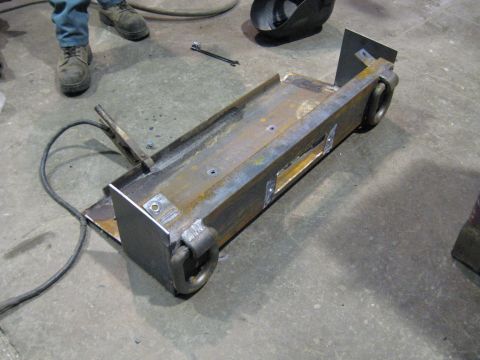 1978 Ford Bronco - A custom-fabricated metal component, possibly a trailer hitch or frame, sits on a workshop floor.