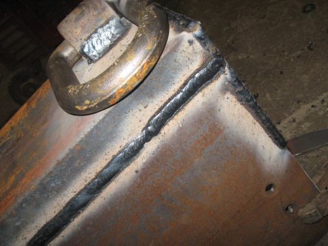 1978 Ford Bronco - Close-up of a welded metal component a large ring and prominent weld lines.