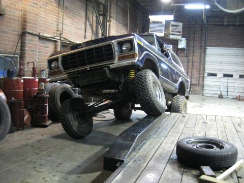 1978 Ford Bronco - This 1978 Ford Bronco is positioned on a ramp inside a workshop.