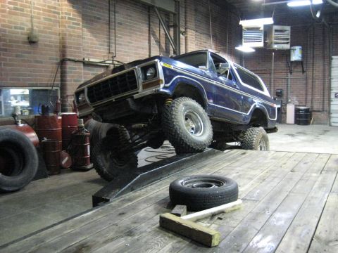 1978 Ford Bronco - 1978 Ford Bronco positioned on a ramp in a workshop setting.
