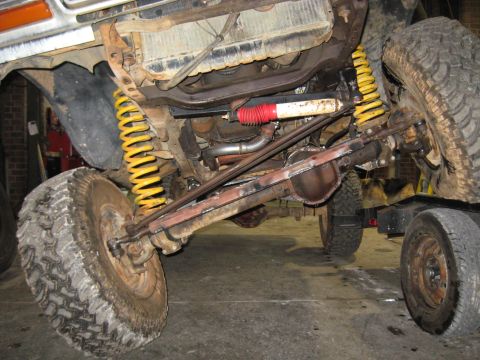 1978 Ford Bronco - Undercarriage view of a 1978 Ford Bronco, showing suspension components and front axle.