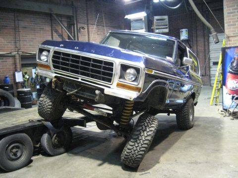 1978 Ford Bronco - A blue 1978 Ford Bronco is shown on a trailer with its suspension lifted.