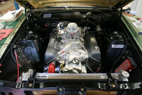 1971 Ford Ranchero - The engine bay of a vehicle, a V8 engine with aftermarket components and a Griffin radiator.