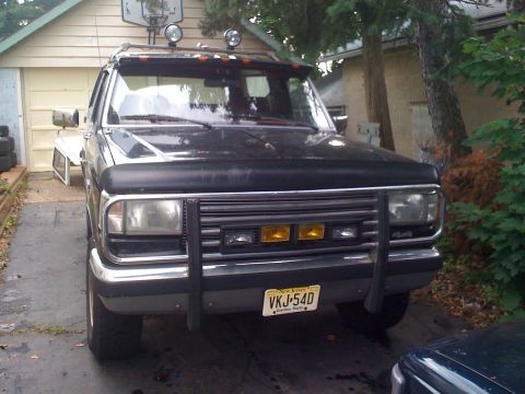1988 Ford Bronco - Front view of a black Ford Bronco with aftermarket modifications.