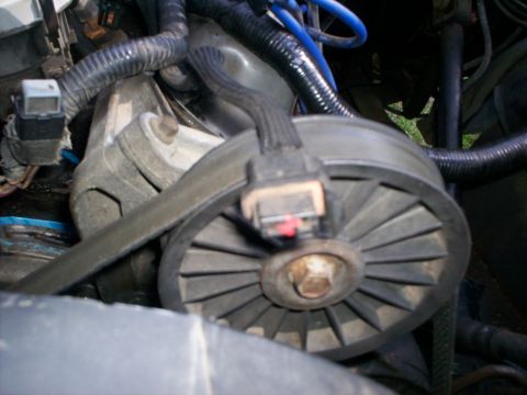 1990 Ford Bronco - This image shows a close-up view of a vehicle's engine belt and pulley system.