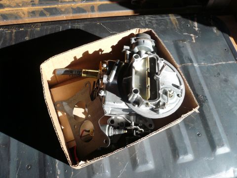 1975 Ford Ranchero - A carburetor and its accompanying gasket are presented in a cardboard box, likely for sale or storage.