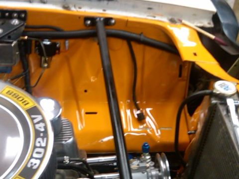 1978 Ford Mustang II - Close-up view of an engine bay bright orange paint and a prominent 302-4V badge.