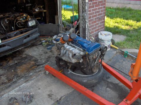 1993 Ford Probe - An engine is suspended on an engine stand, ready for installation or removal from a vehicle.