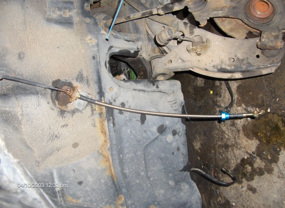 Undercarriage view of a car's brake line assembly. Timestamp 04/10/2003 12:30 pm