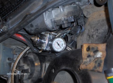 1993 Ford Probe - Close-up view of engine bay components, including a fuel pressure regulator and gauge, with a timestamp from 2003.