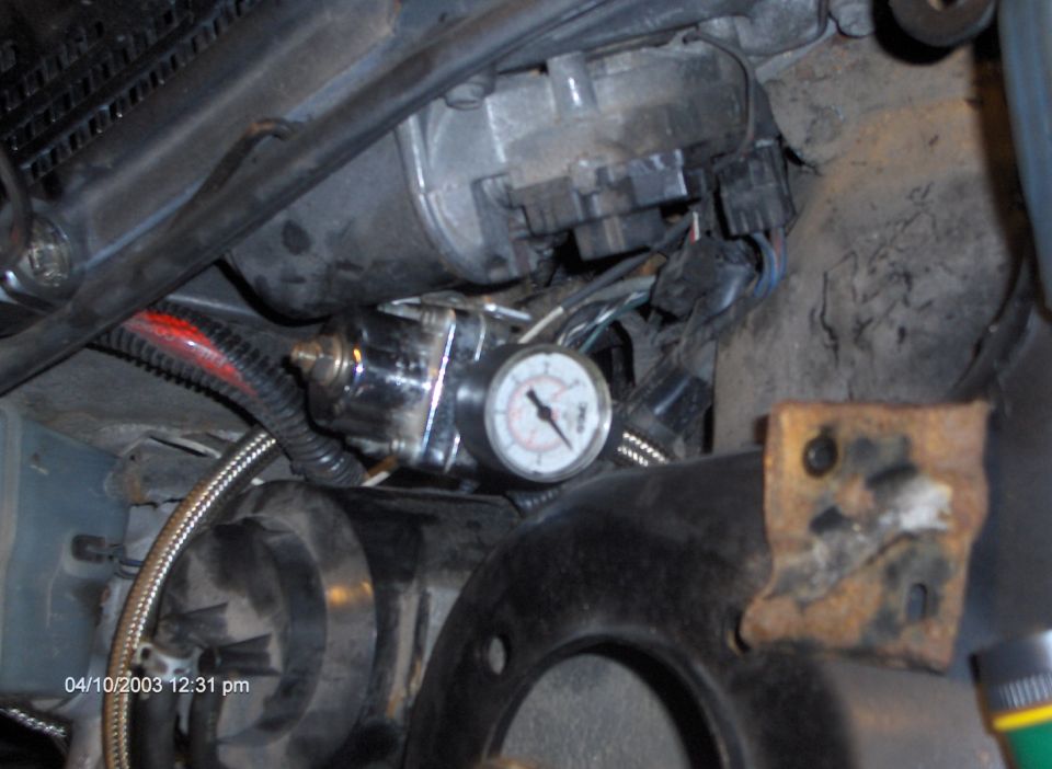 Engine bay with fuel pressure regulator and gauge. Date stamp reads 04/10/2003