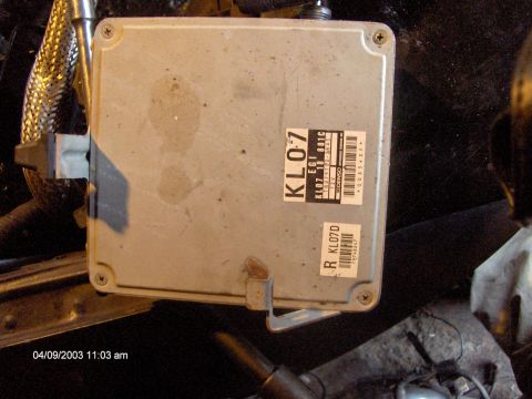 1993 Ford Probe - Close-up of an engine control unit, likely from a vehicle, with visible part numbers and manufacturer labels.