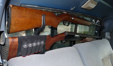 2006 Ford E350 - Interior view of a vehicle with two firearms secured behind the seats.