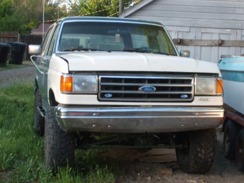 1989 Ford Bronco - This Ford Bronco features a prominent grille with the Ford logo and 4x4 badging on the front fender.
