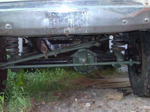 1989 Ford Bronco - Close-up view of a vehicle's undercarriage, focusing on the suspension and steering components.