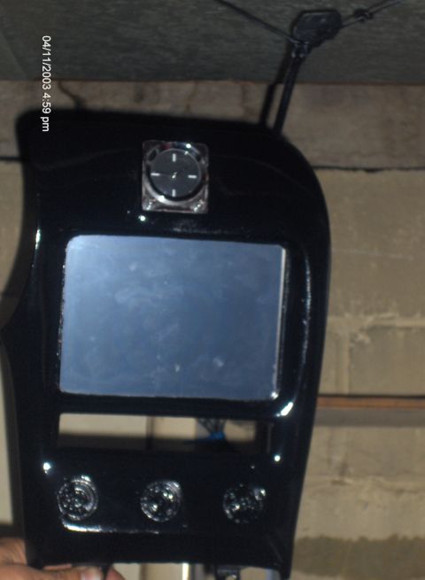 1993 Ford Probe - Center console part with screen, clock, and knobs, possibly from an older car.