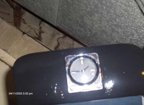 1993 Ford Probe - A close-up view of a car's dashboard clock, showing the time and chrome detailing.