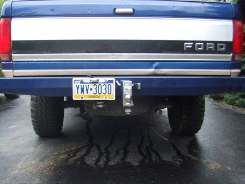 1996 Ford Bronco - The rear of a blue Ford truck shows its license plate and tow hitch.