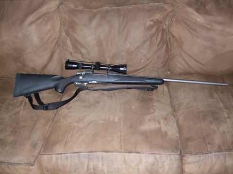 1988 Ford Bronco - Rifle with scope and sling on a couch.