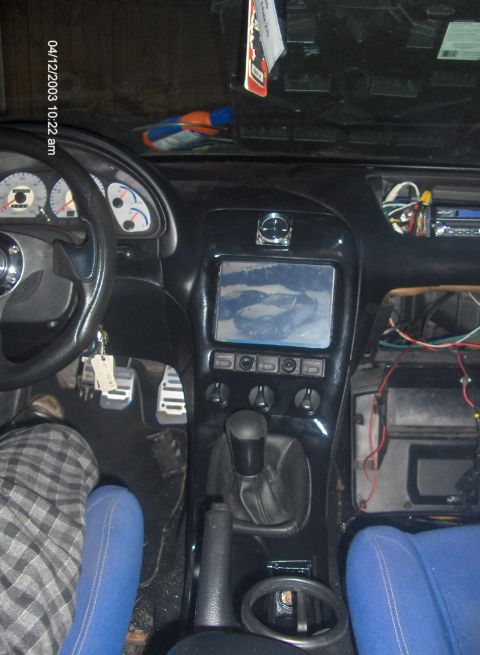1993 Ford Probe - Interior view of a car's dashboard, an aftermarket screen and visible wiring.