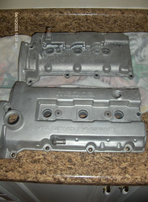 1993 Ford Probe - Two engine valve covers are shown, one above the other, with visible text indicating 'MAZDA' and 'V6 DOHC 24-VALVE'.