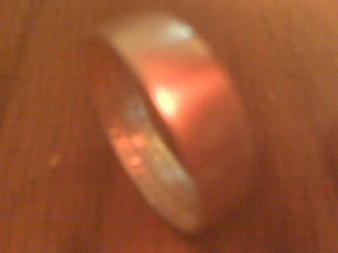 1995 Ford Bronco - A coin ring is shown in detail, with a bright light source causing a red reflection.