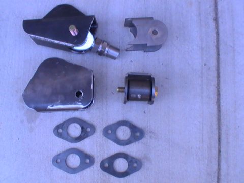 1997 Ford Ranger - Various custom-fabricated metal parts, likely for a vehicle's suspension system, are laid out on a concrete surface.