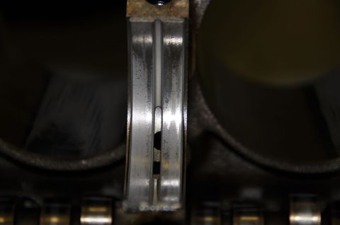 1996 Ford Bronco - Close-up view of an engine bearing, showing signs of wear and damage.