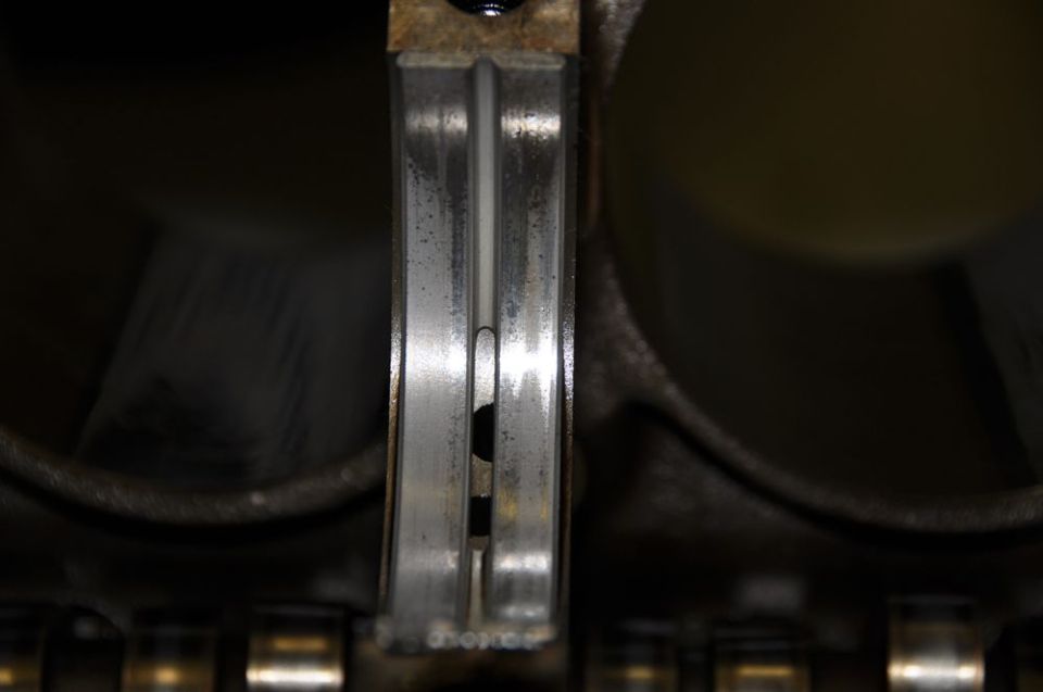 Engine bearing with visible wear and a dark spot