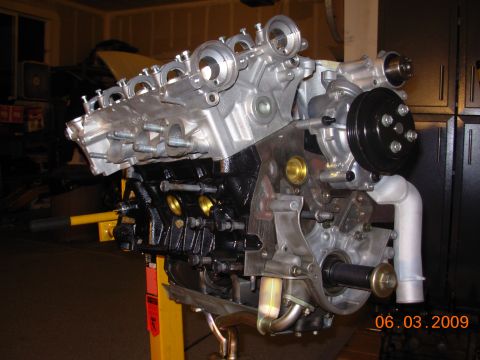 1995 Ford Taurus - A V6 engine is mounted on a yellow engine stand, ready for work or display.