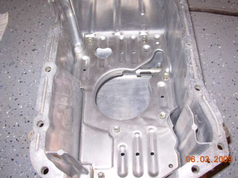 1995 Ford Taurus - Close-up of an aluminum oil pan, likely for an engine rebuild or repair.