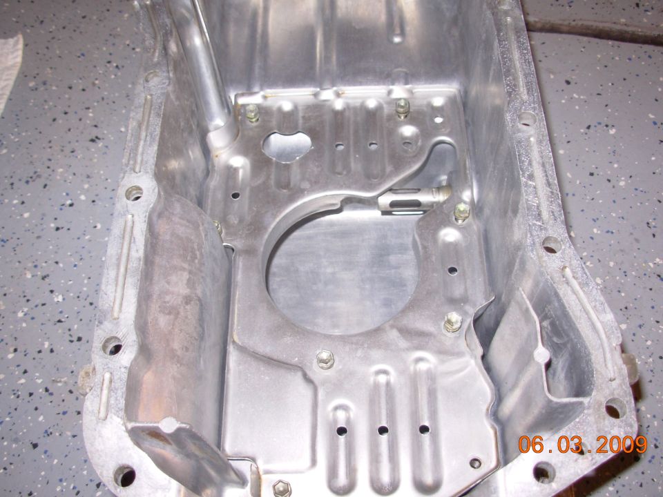 Aluminum oil pan with mounting bolts and internal baffles