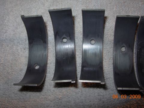 1995 Ford Taurus - Several engine bearings are shown, displaying wear and oil passages. A date stamp indicates 06.03.2009.